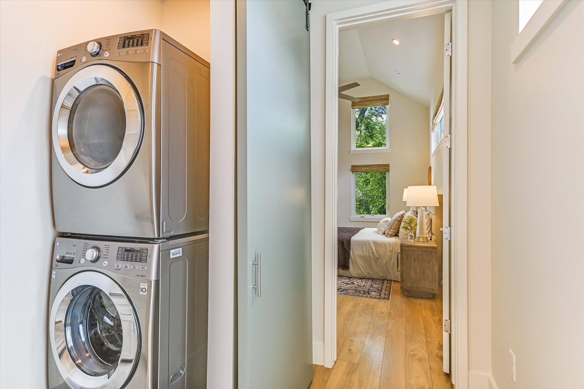 1605 Hether Street Austin, TX 78704 - Photo 18 of 26 Integrated laundry area featuring stacked front-load washer and dryer units