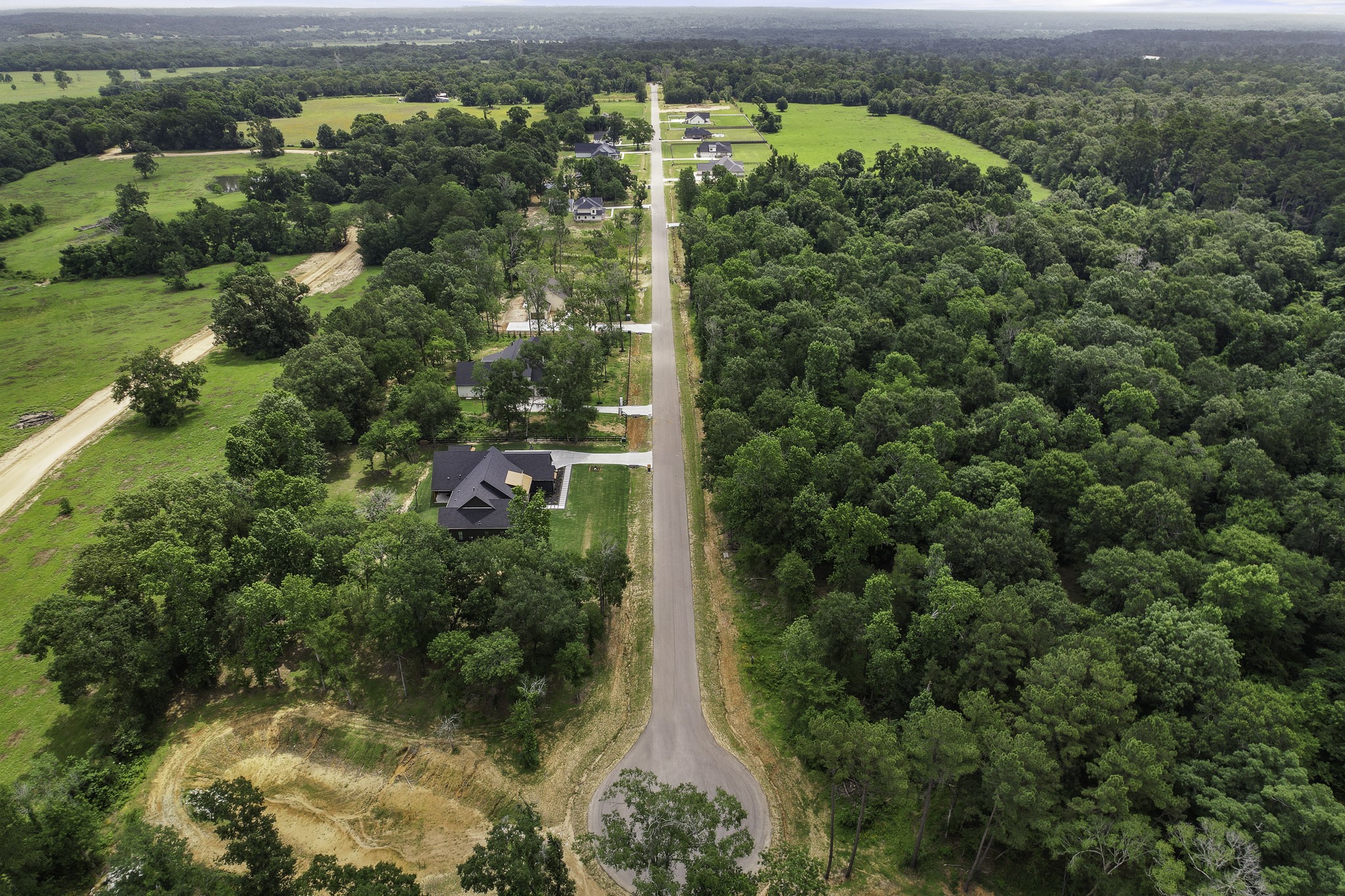 24912 Two Rivers Road Montgomery, TX 77316 - Photo 5 of 7 an aerial view of residential houses with outdoor space and trees