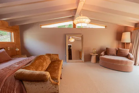 a bedroom with a bed and couch