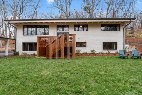 a view of a backyard with table and chairs and wooden fence