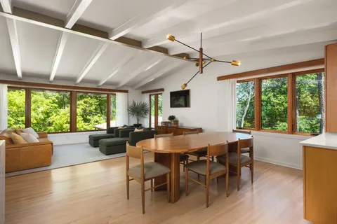 a view of a dining room with furniture window and wooden floor