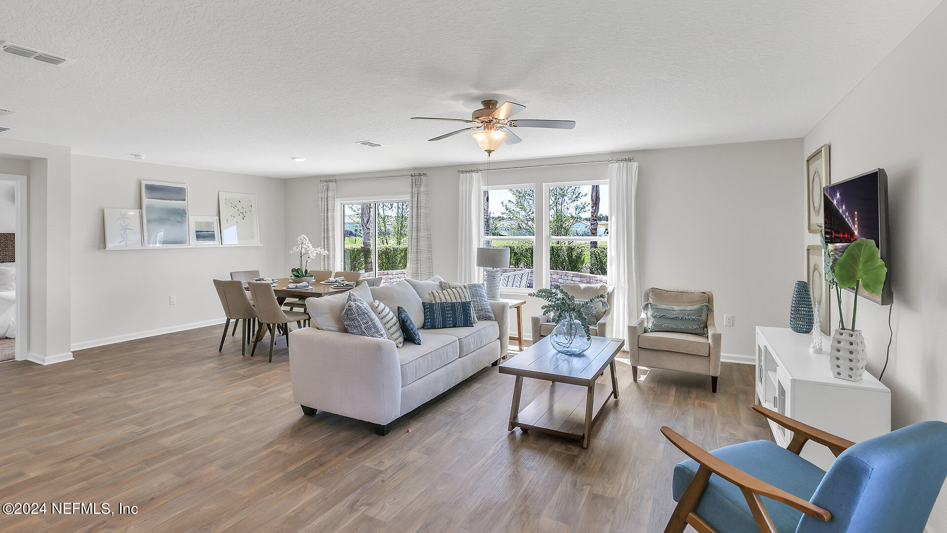 114 Hulett Wds Road Palm Coast, FL 32137 - Photo 11 of 36 a living room with furniture and a flat screen tv