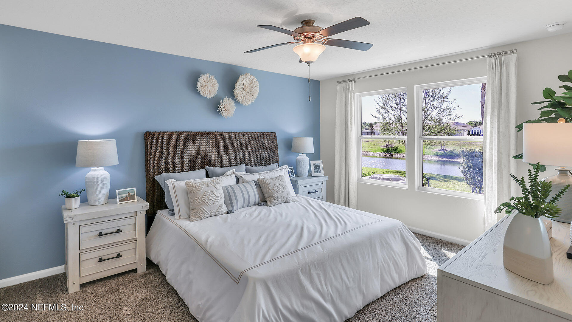 114 Hulett Wds Road Palm Coast, FL 32137 - Photo 17 of 36 a bedroom with a large bed and a window