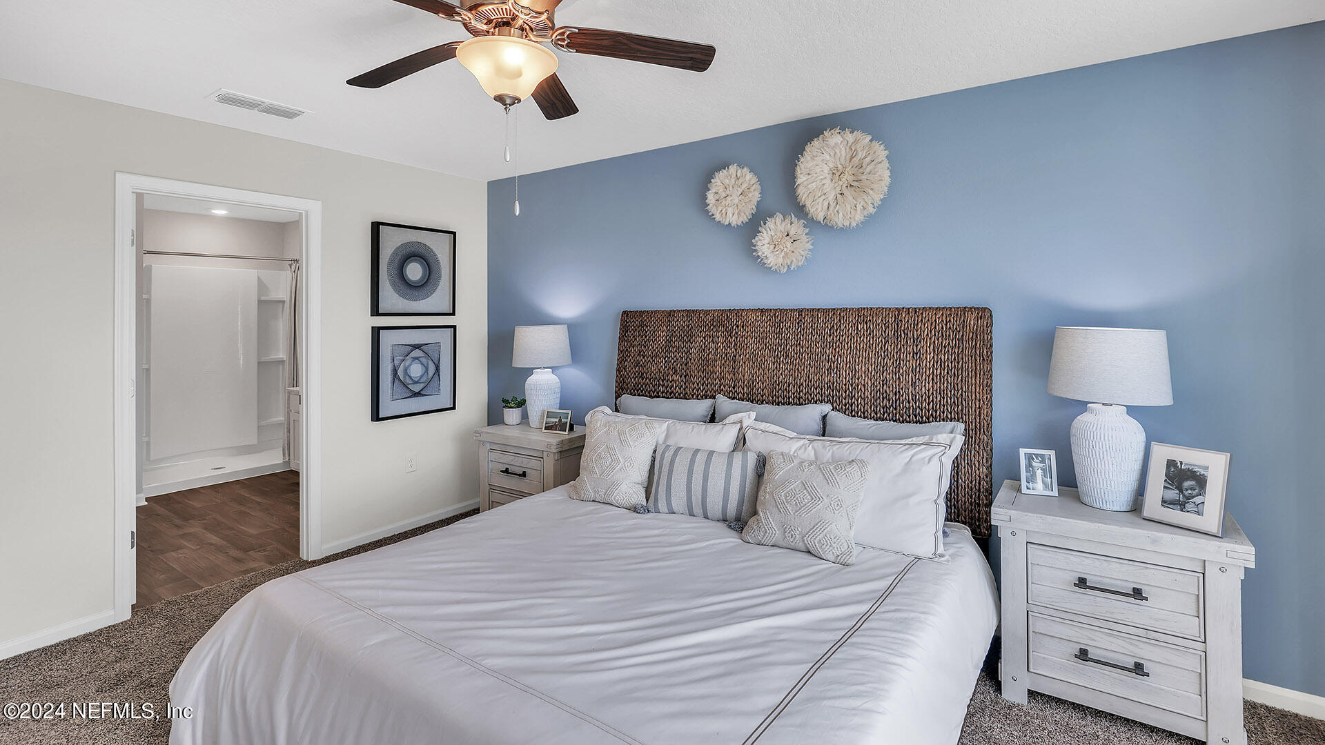 114 Hulett Wds Road Palm Coast, FL 32137 - Photo 18 of 36 a bedroom with a bed and a chandelier