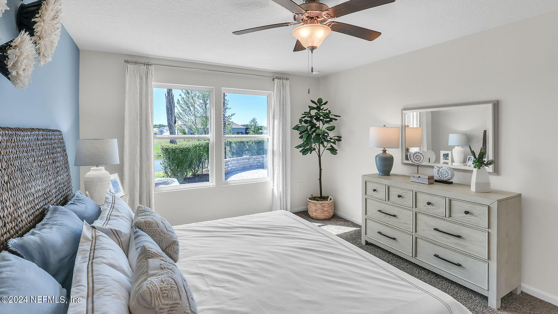 114 Hulett Wds Road Palm Coast, FL 32137 - Photo 19 of 36 a bedroom with a large bed and a window