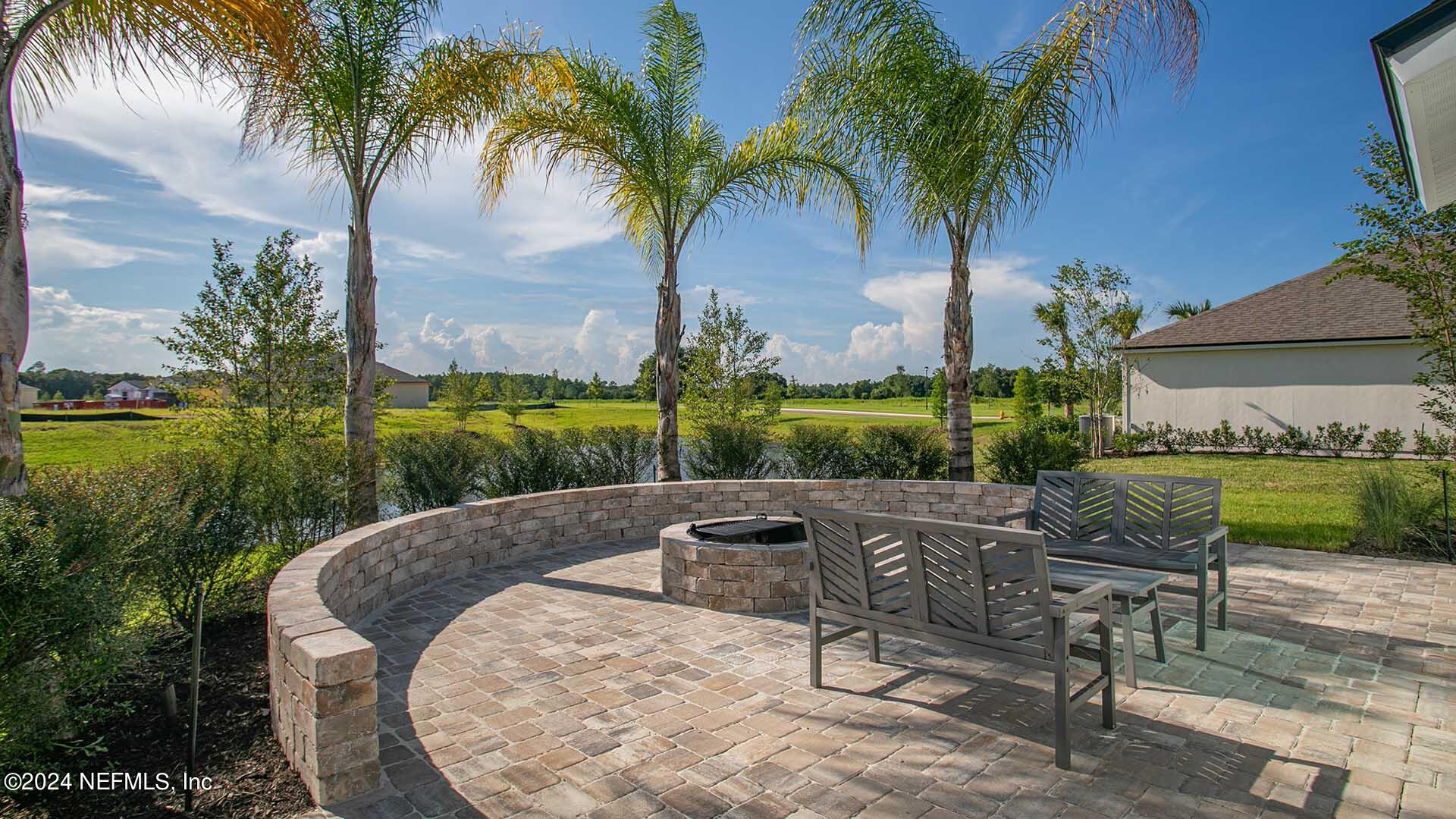 114 Hulett Wds Road Palm Coast, FL 32137 - Photo 27 of 36 a view of a backyard with plants and palm tree