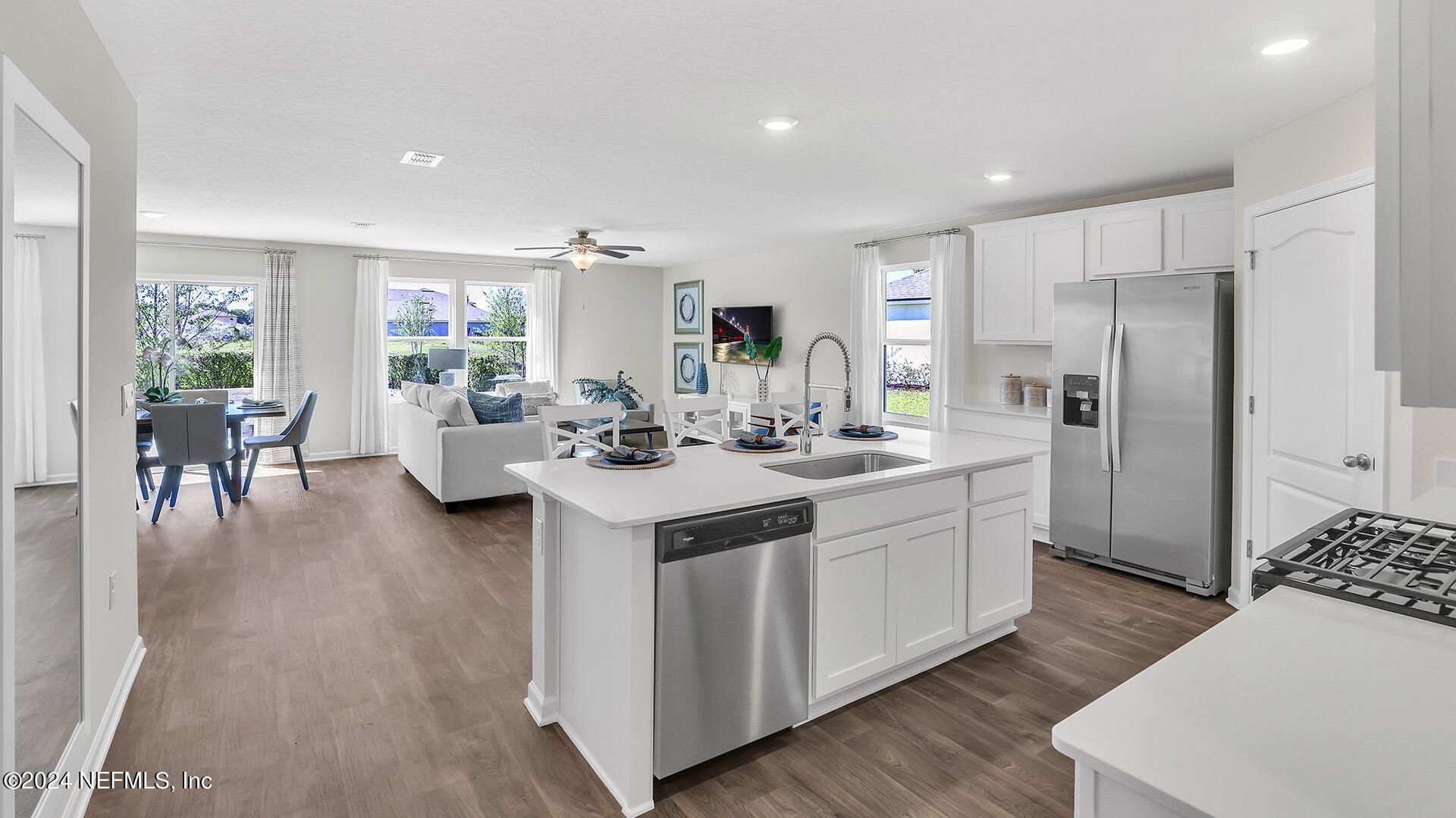 114 Hulett Wds Road Palm Coast, FL 32137 - Photo 7 of 36 a kitchen with sink refrigerator and dining table