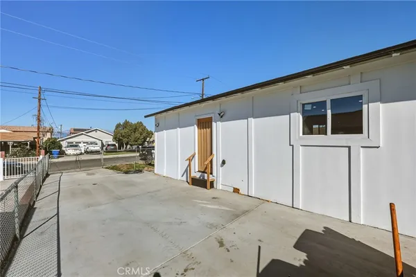 a view of a house with backyard and sitting area