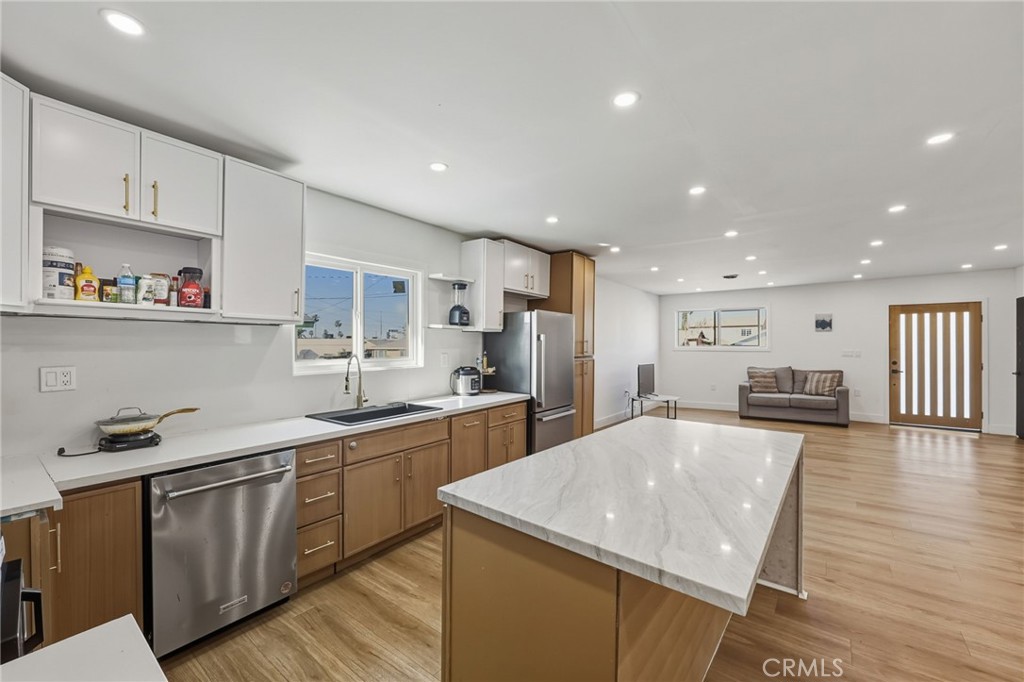 7830 Casa Blanca Street Riverside, CA 92504 - Photo 8 of 27 a kitchen with stainless steel appliances granite countertop a sink stove and refrigerator