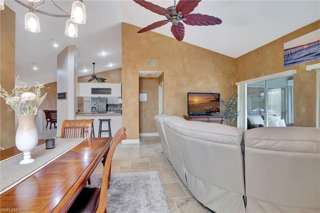2103 Tama Circle, Unit 202 Naples, FL 34112 - Photo 14 of 28 a living room with furniture and a flat screen tv