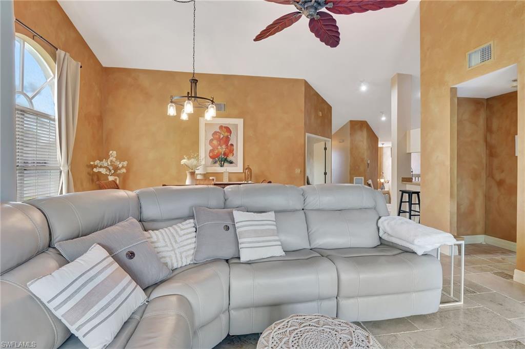 2103 Tama Circle, Unit 202 Naples, FL 34112 - Photo 16 of 28 a living room with furniture and a chandelier