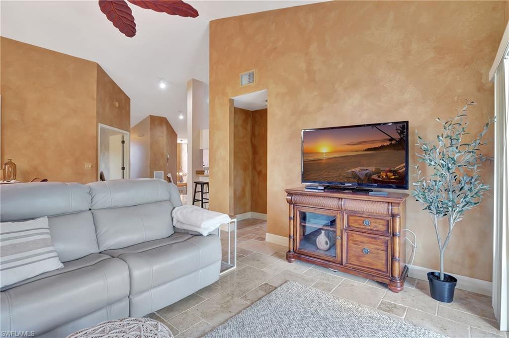 2103 Tama Circle, Unit 202 Naples, FL 34112 - Photo 17 of 28 a living room with furniture and a flat screen tv