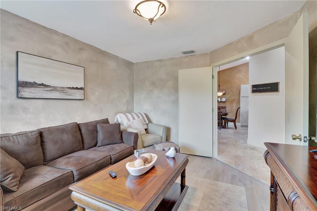 2103 Tama Circle, Unit 202 Naples, FL 34112 - Photo 25 of 28 a living room with furniture and wooden floor