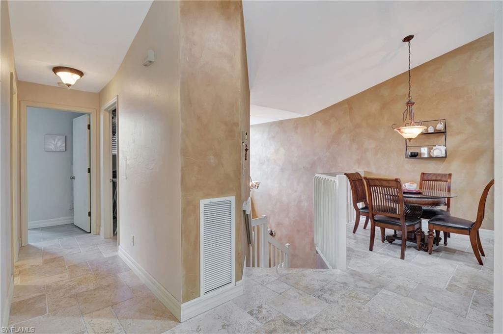 2103 Tama Circle, Unit 202 Naples, FL 34112 - Photo 5 of 28 a view of a dining room with furniture