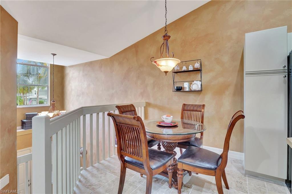 2103 Tama Circle, Unit 202 Naples, FL 34112 - Photo 10 of 28 a view of a dining room with furniture and a window