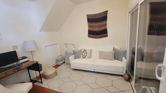 a bedroom with a bed and a chair