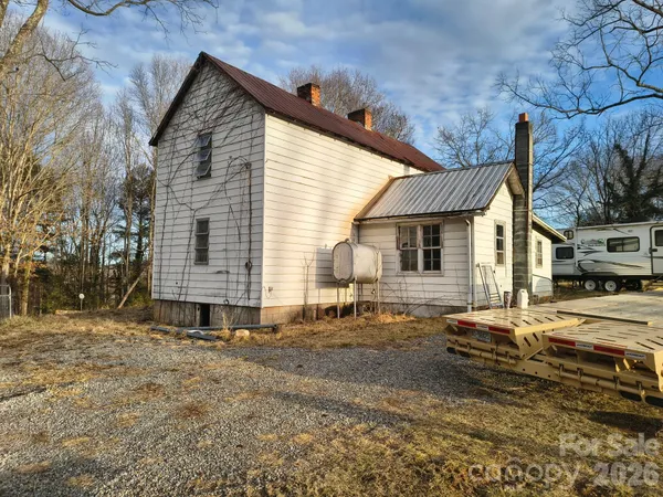 a view of a house with a yard and sitting area