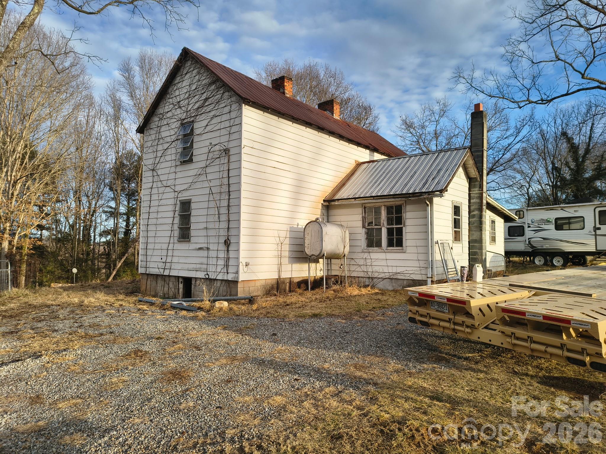 a view of a house with a yard and sitting area