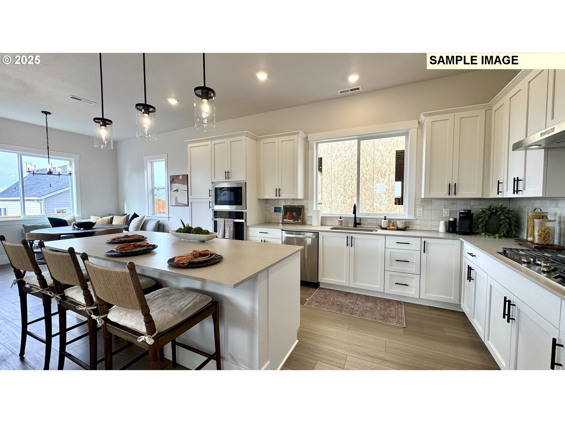 17714 Southwest Watchman Lane Beaverton, OR 97007 - Photo 18 of 22 a open kitchen with stainless steel appliances kitchen island granite countertop a sink and cabinets