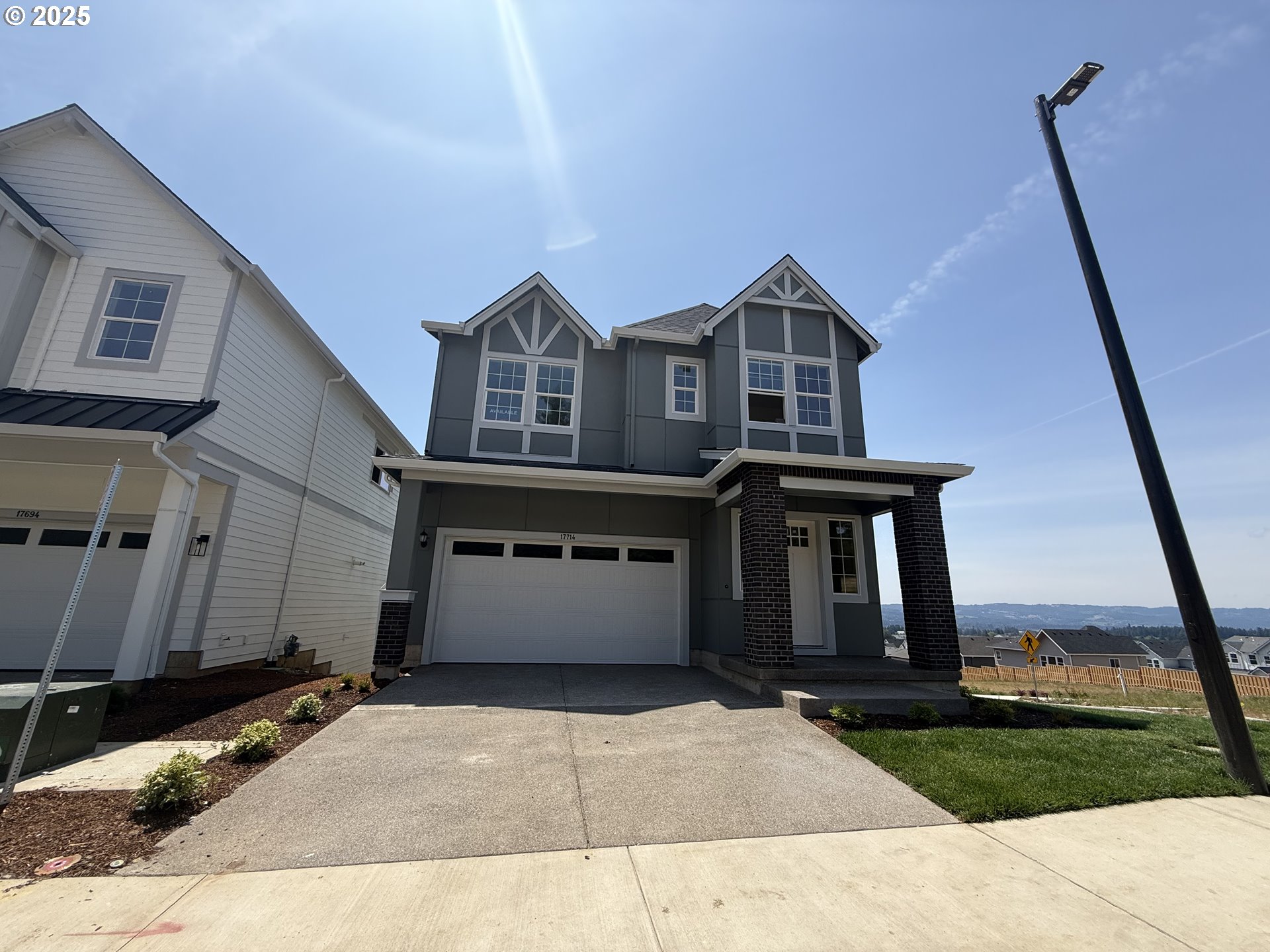 17714 Southwest Watchman Lane Beaverton, OR 97007 - Photo 2 of 22 a front view of a house with a yard