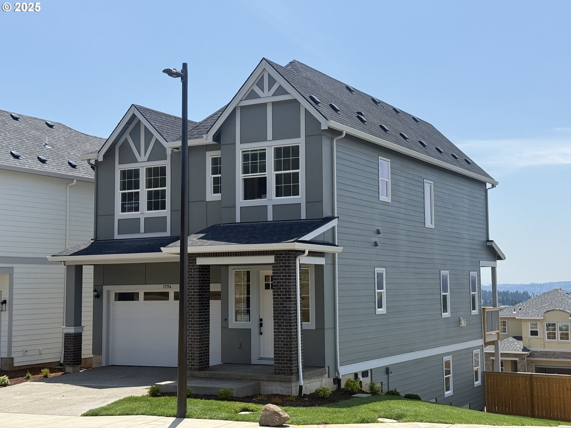 17714 Southwest Watchman Lane Beaverton, OR 97007 - Photo 3 of 22 a front view of a house with a yard