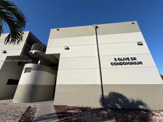 an empty room with a ceiling fan and window