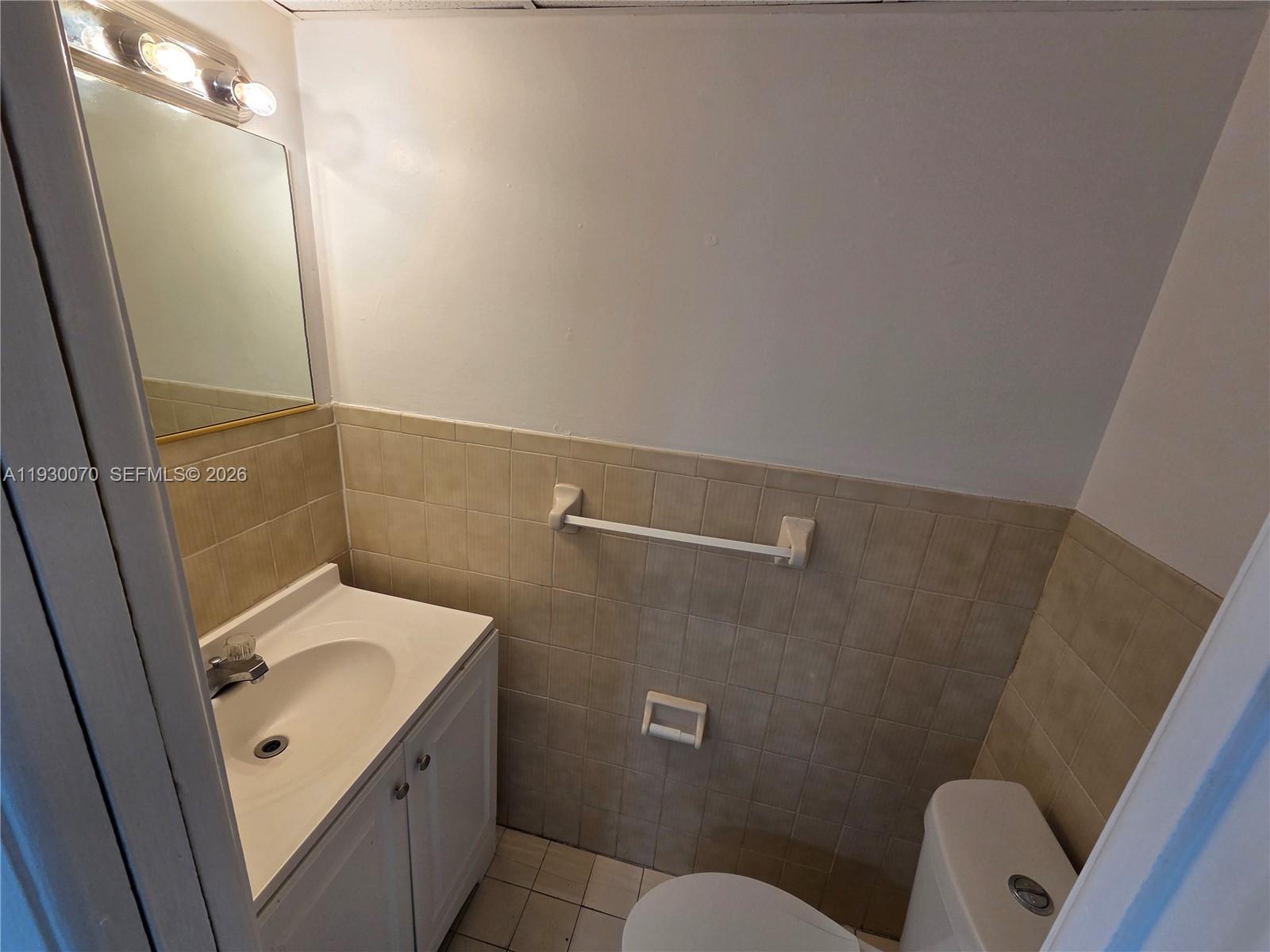 5 Olive Drive, Unit 24 Hialeah, FL 33010 - Photo 5 of 16 a bathroom with a sink a toilet and shower