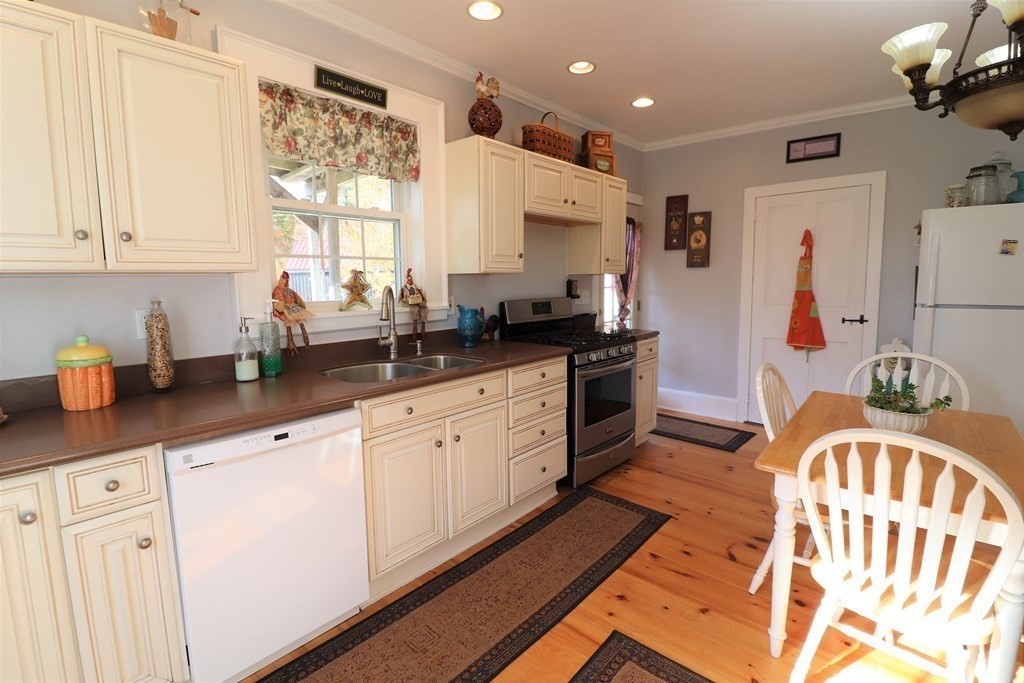 751 Snipatuit Road Rochester, MA 02770 - Photo 11 of 42 a kitchen with stainless steel appliances granite countertop a sink dishwasher a refrigerator and white cabinets with wooden floor