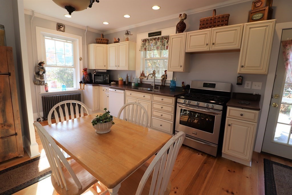 751 Snipatuit Road Rochester, MA 02770 - Photo 12 of 42 a kitchen with granite countertop a stove a sink a refrigerator and white cabinets with wooden floor