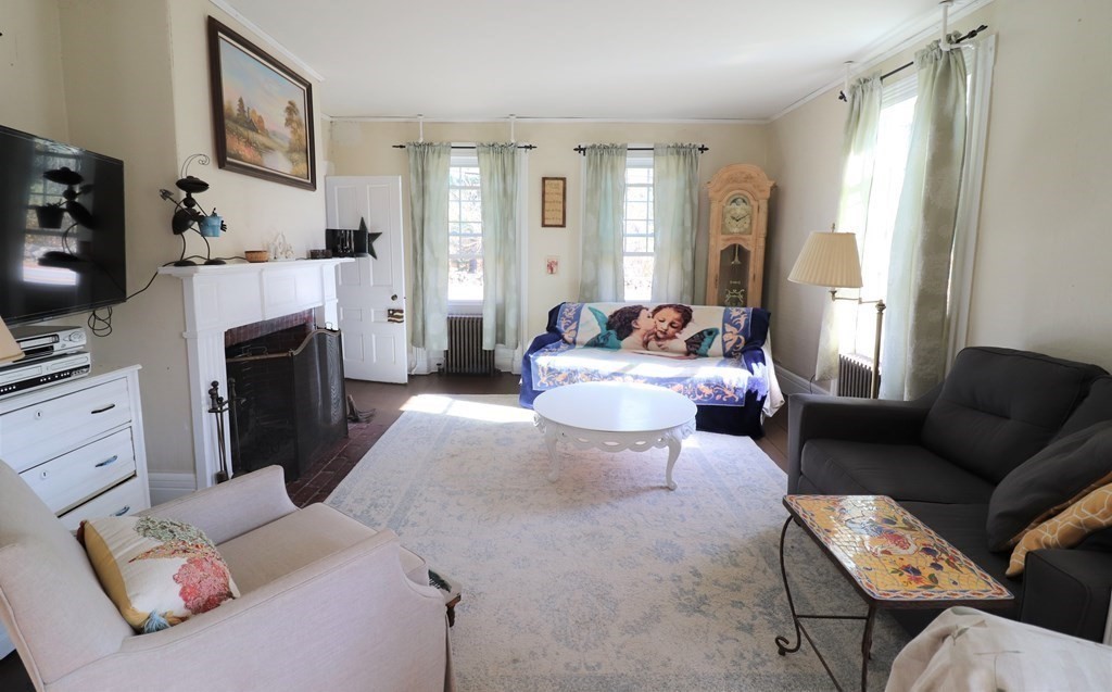 751 Snipatuit Road Rochester, MA 02770 - Photo 21 of 42 a living room with furniture and a fireplace