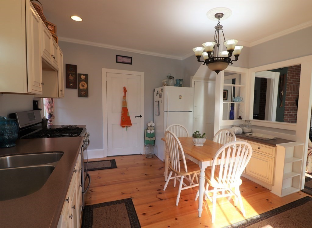 751 Snipatuit Road Rochester, MA 02770 - Photo 10 of 42 a view of a dining room with furniture and chandelier