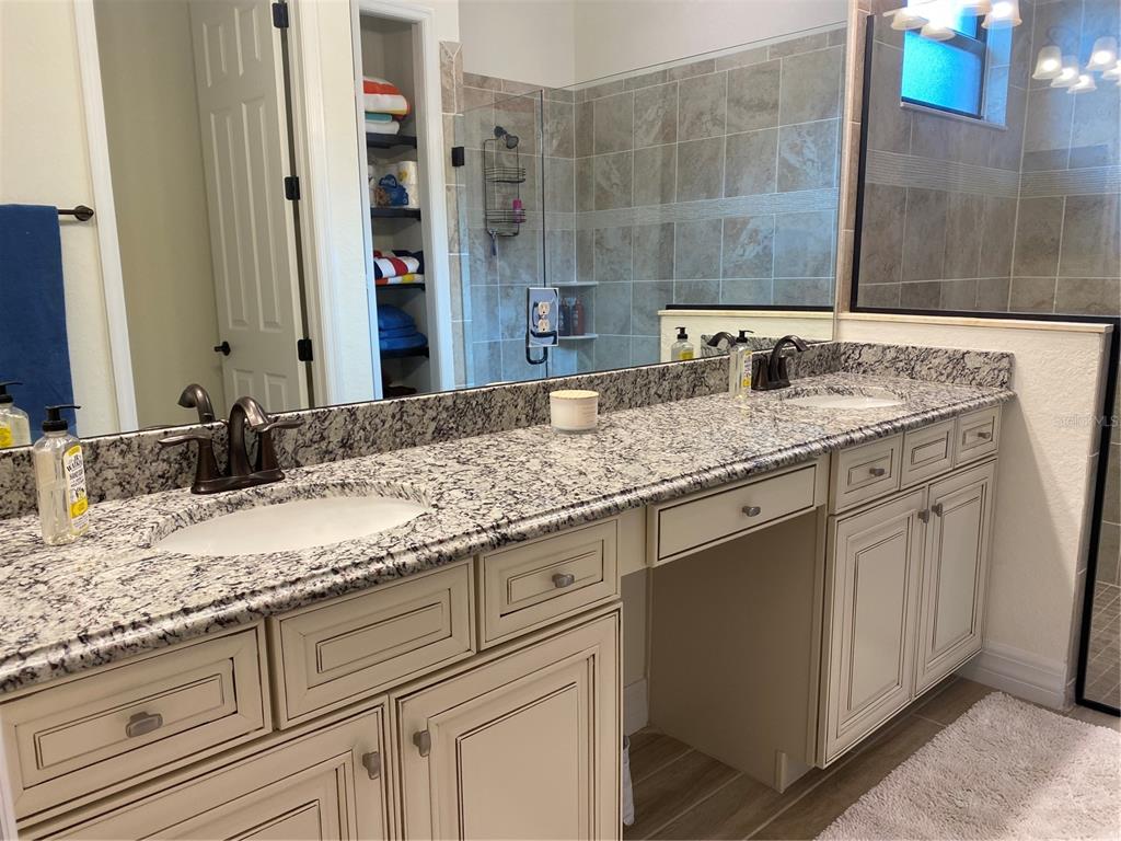 17525 Hickok Belt Loop Bradenton, FL 34211 - Photo 13 of 31 a bathroom with a granite countertop sink and a mirror