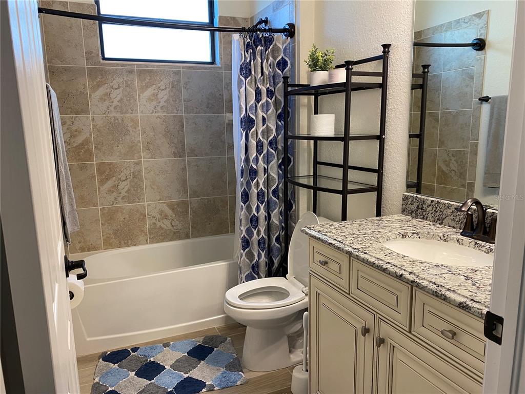 17525 Hickok Belt Loop Bradenton, FL 34211 - Photo 19 of 31 a bathroom with a sink a toilet and shower