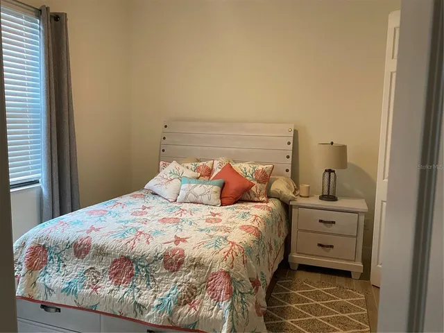 a bed sitting in a bedroom next to a bathroom