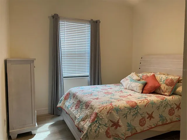 a bedroom with a bed and a window