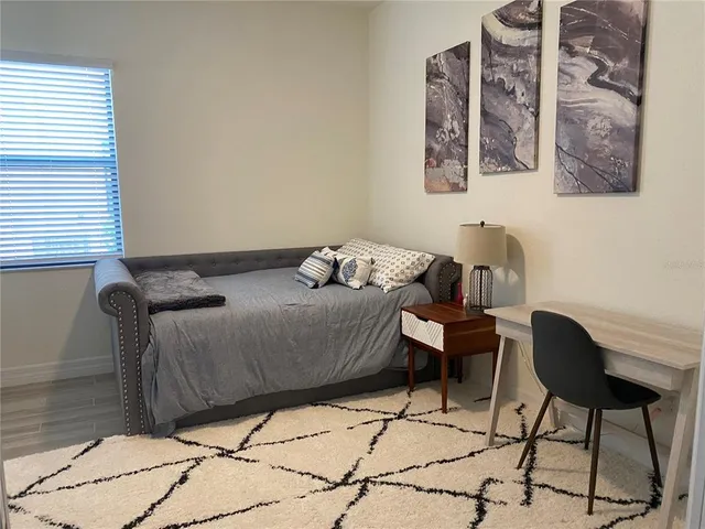 a bedroom with a bed and chair