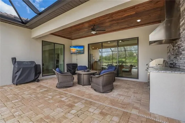 a living room with furniture a lamp and a potted plant