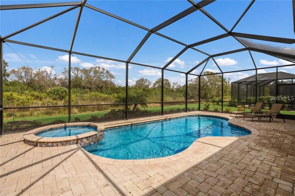 17525 Hickok Belt Loop Bradenton, FL 34211 - Photo 28 of 31 a view of a swimming pool with a porch