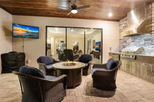 a dining room with furniture a rug and a flat screen tv