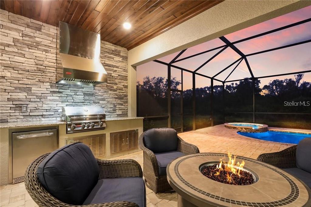 17525 Hickok Belt Loop Bradenton, FL 34211 - Photo 30 of 31 a table and chairs sitting in a kitchen
