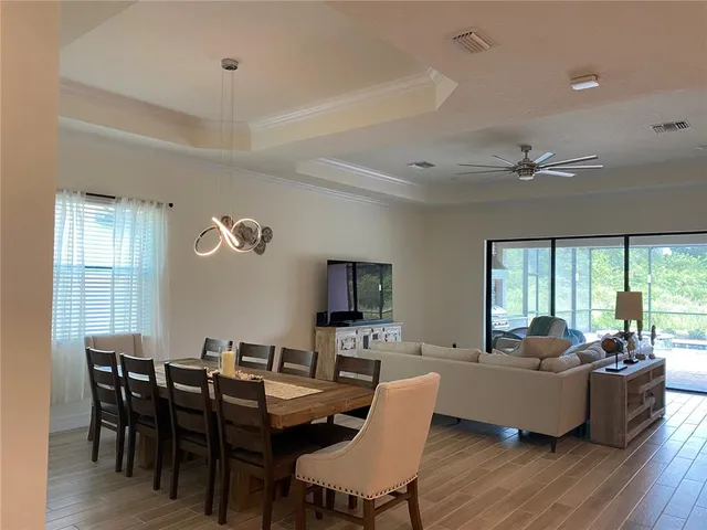 a living room with fireplace furniture and a large window