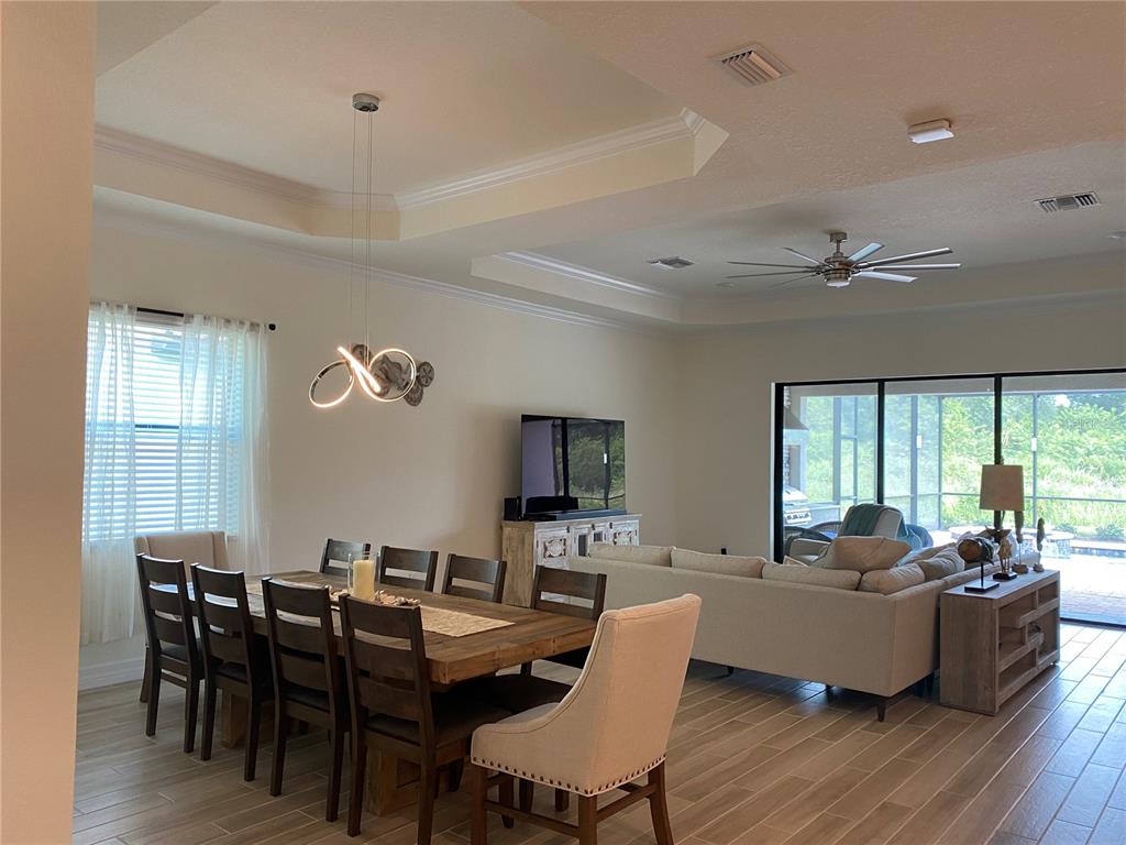 17525 Hickok Belt Loop Bradenton, FL 34211 - Photo 3 of 31 a living room with fireplace furniture and a large window