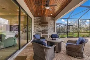 a dining room with furniture and a floor to ceiling window