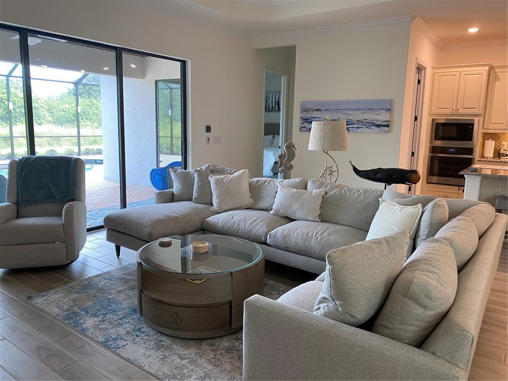 17525 Hickok Belt Loop Bradenton, FL 34211 - Photo 8 of 31 a living room with furniture and a large window