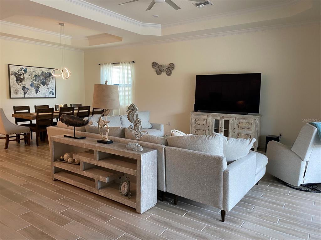 17525 Hickok Belt Loop Bradenton, FL 34211 - Photo 10 of 31 a living room with furniture and a flat screen tv