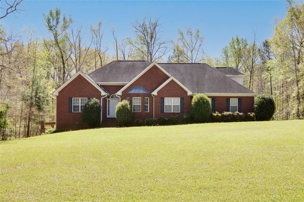 224 Reeves Road Jackson, GA 30233 - Photo 1 of 1 a front view of a house with a yard