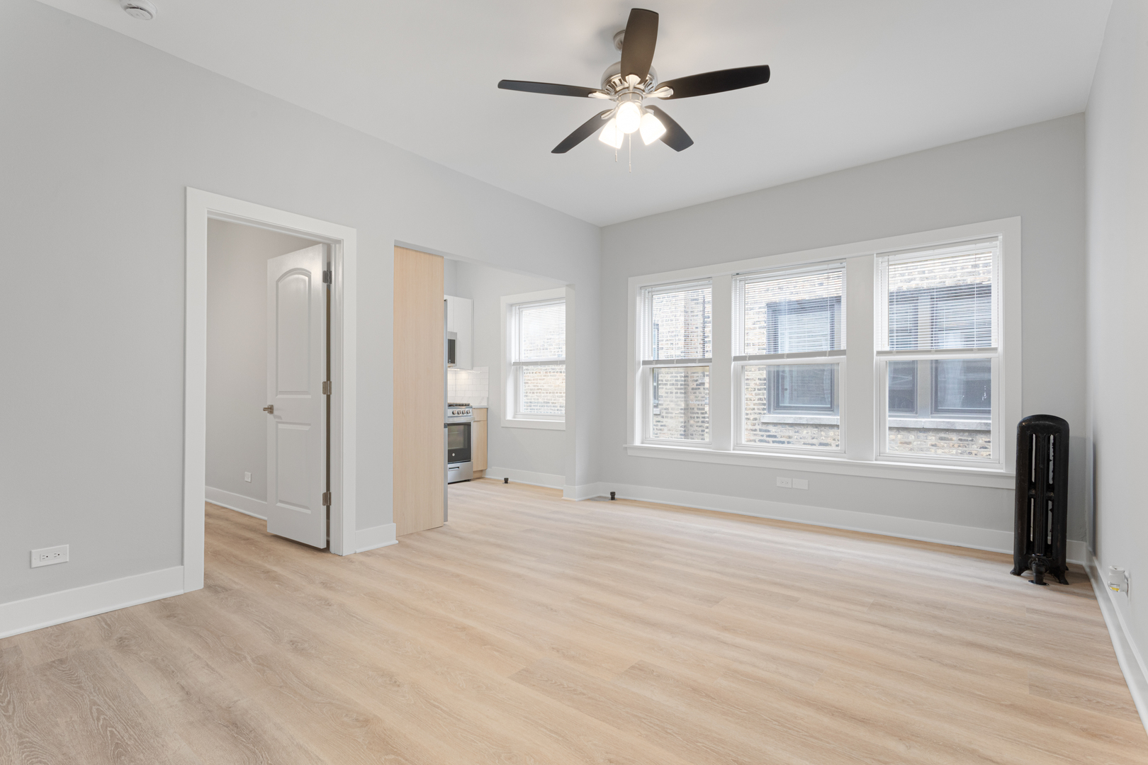 7600 North Sheridan Road, Unit 203 Chicago, IL 60626 - Photo 2 of 10 wooden floor in an empty room with a window