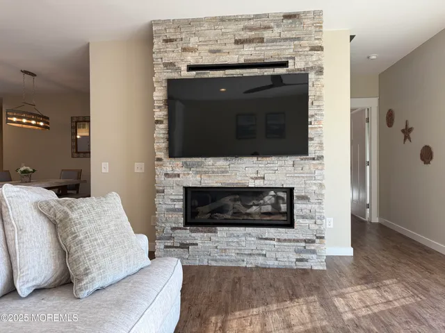 a living room with furniture a flat screen tv and a fireplace