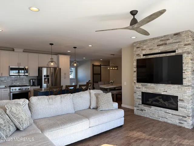 a living room with furniture and a fireplace