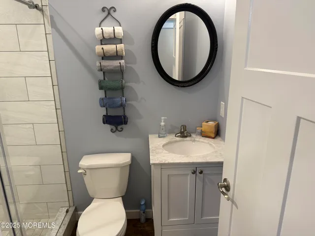 a bathroom with a toilet sink and mirror